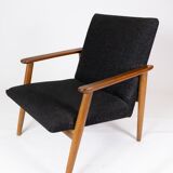 Easy chair with stool in teak and dark wool fabric of danish design from the 1960s.