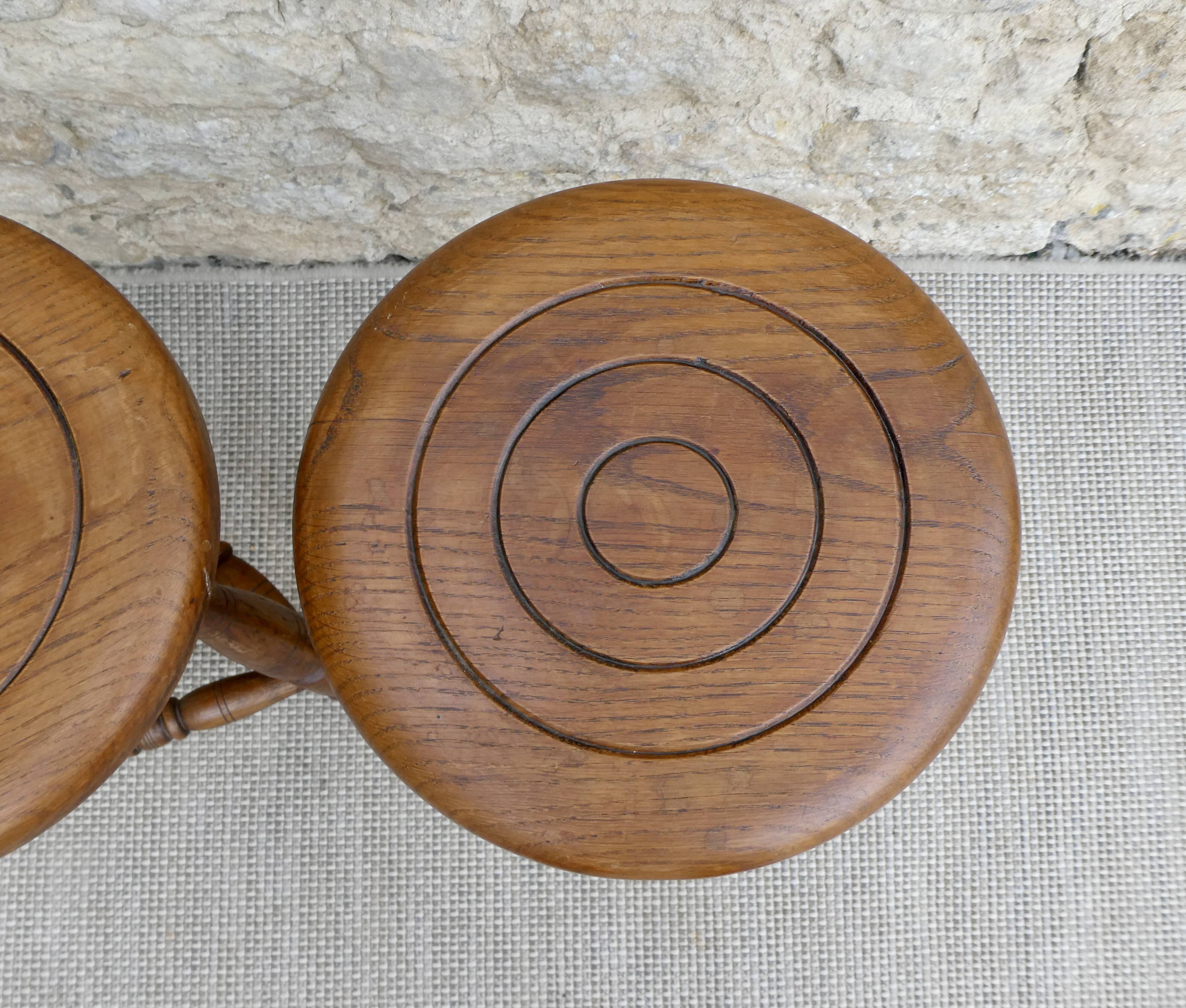 Pair of solid wood tripod stools, carved.
