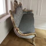 A soft light blue and silver tufted beech wood sofa in Louis style.