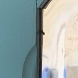 Beveled mirror on turquoise Parisian door