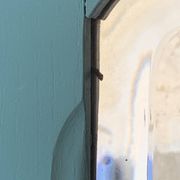 Beveled mirror on turquoise Parisian door