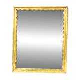 Old mercury mirror in carved wood, gilded with leaf.