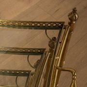 Set of 3 vintage Hollywood Regency nesting tables with brass frame and glass tops (1960s)