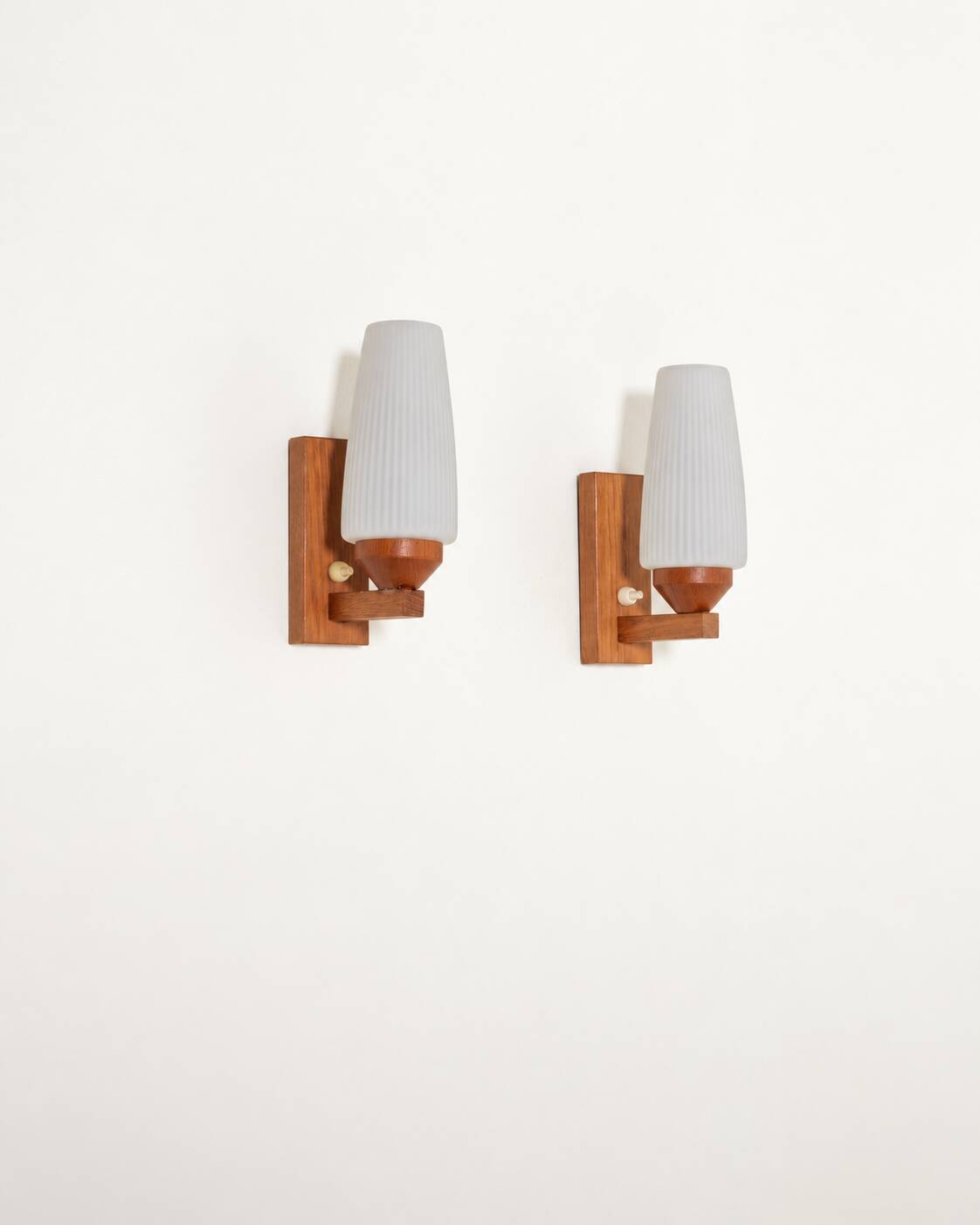 Pair of teak and opaline glass wall lamps, 1950s/1960s