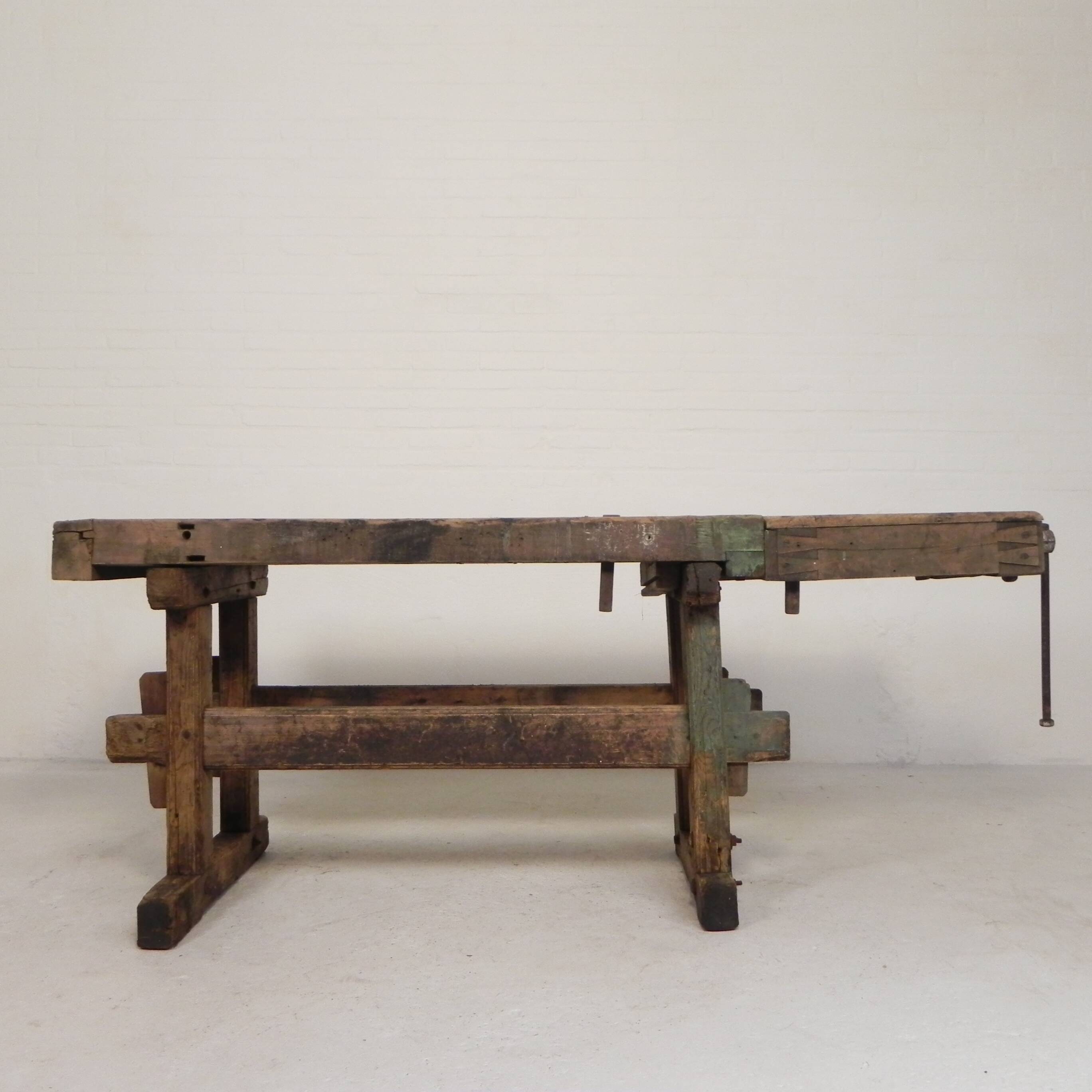 Wooden industrial workbench with vice, 194 cm long, 1930s.
