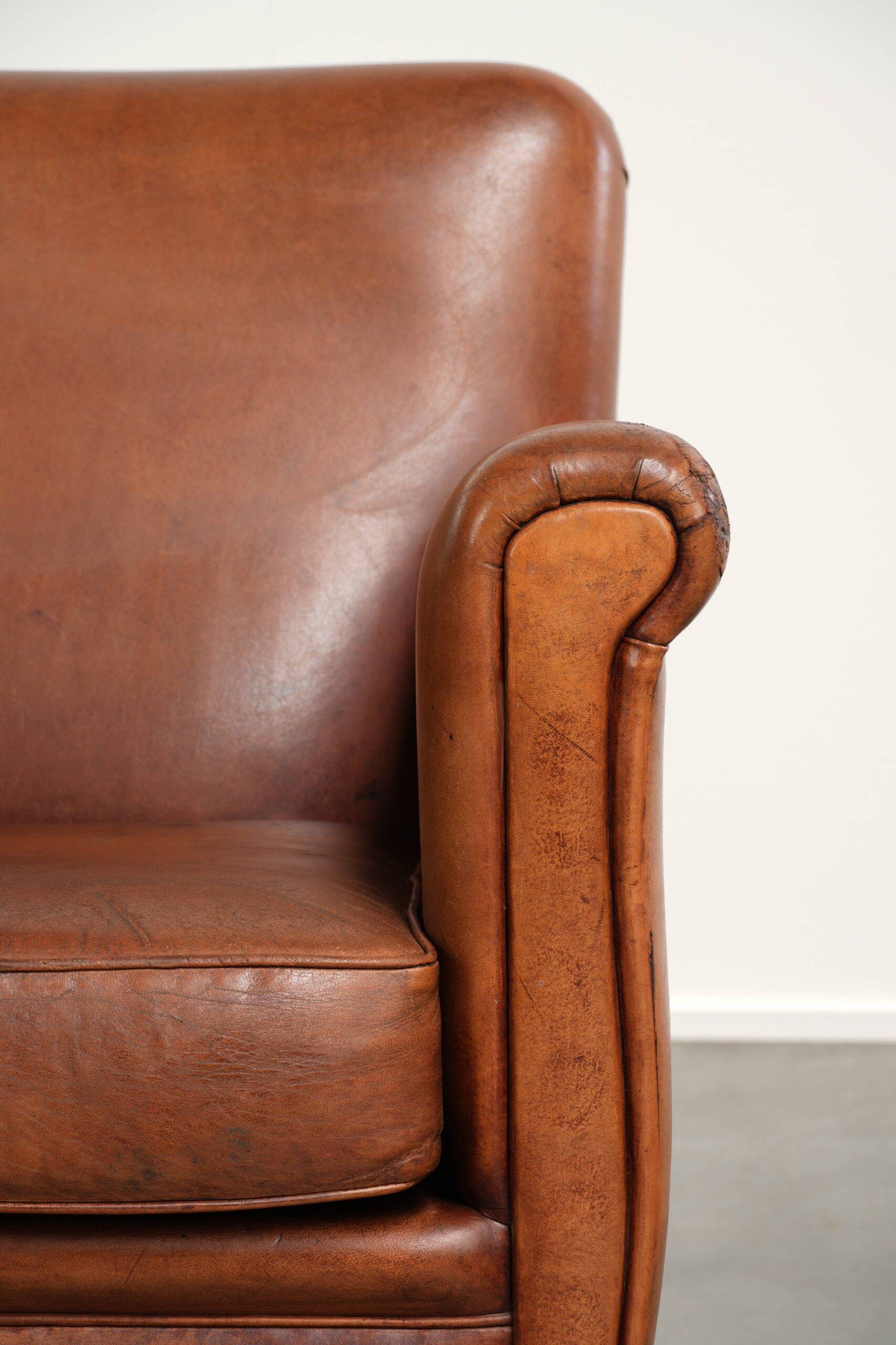 Sturdy vintage sheepskin armchair with a beautiful cognac colour