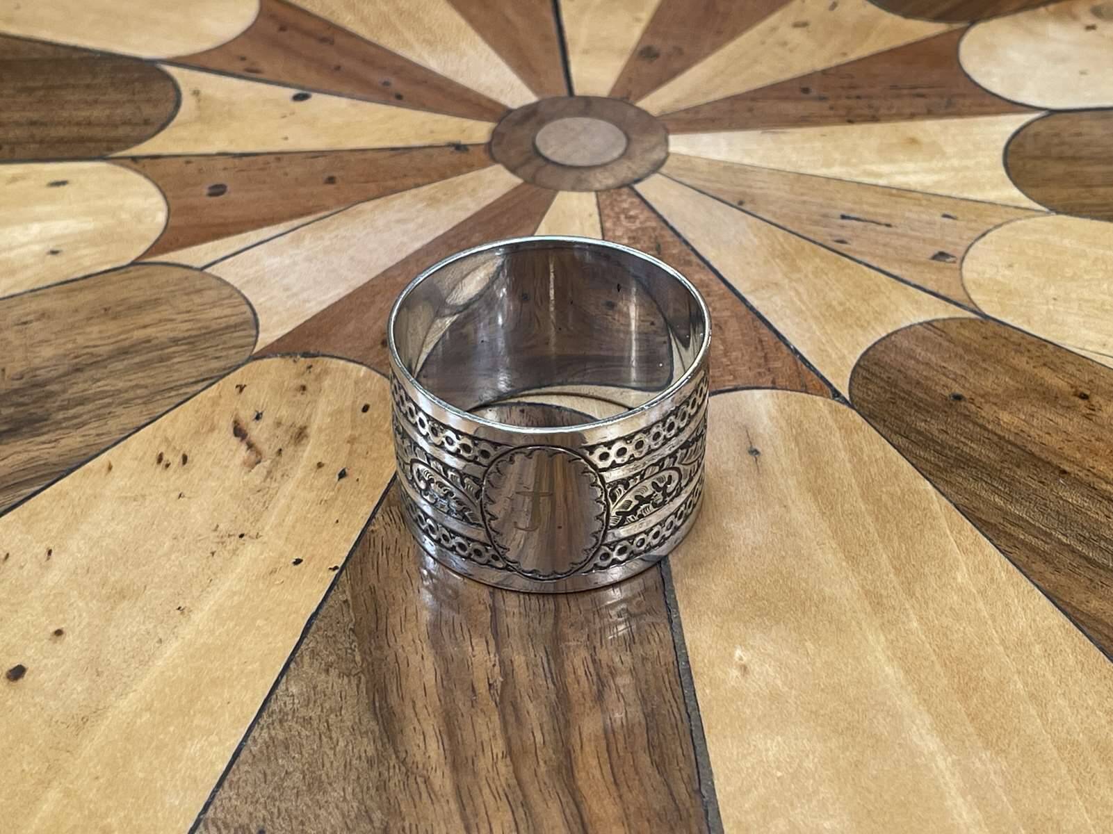 Silver metal napkin ring with the letter J