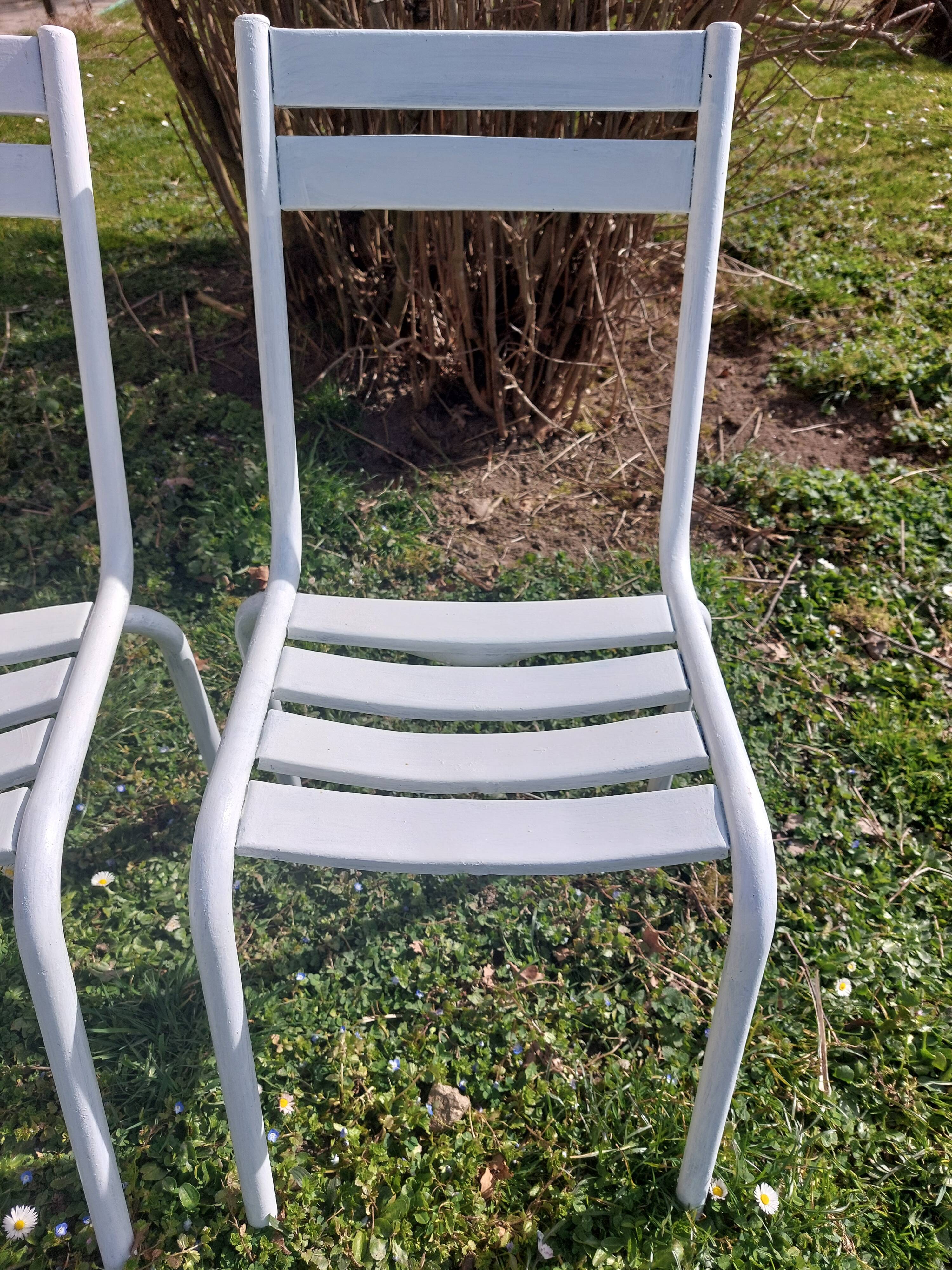 pair of white metal chairs, Tolix style