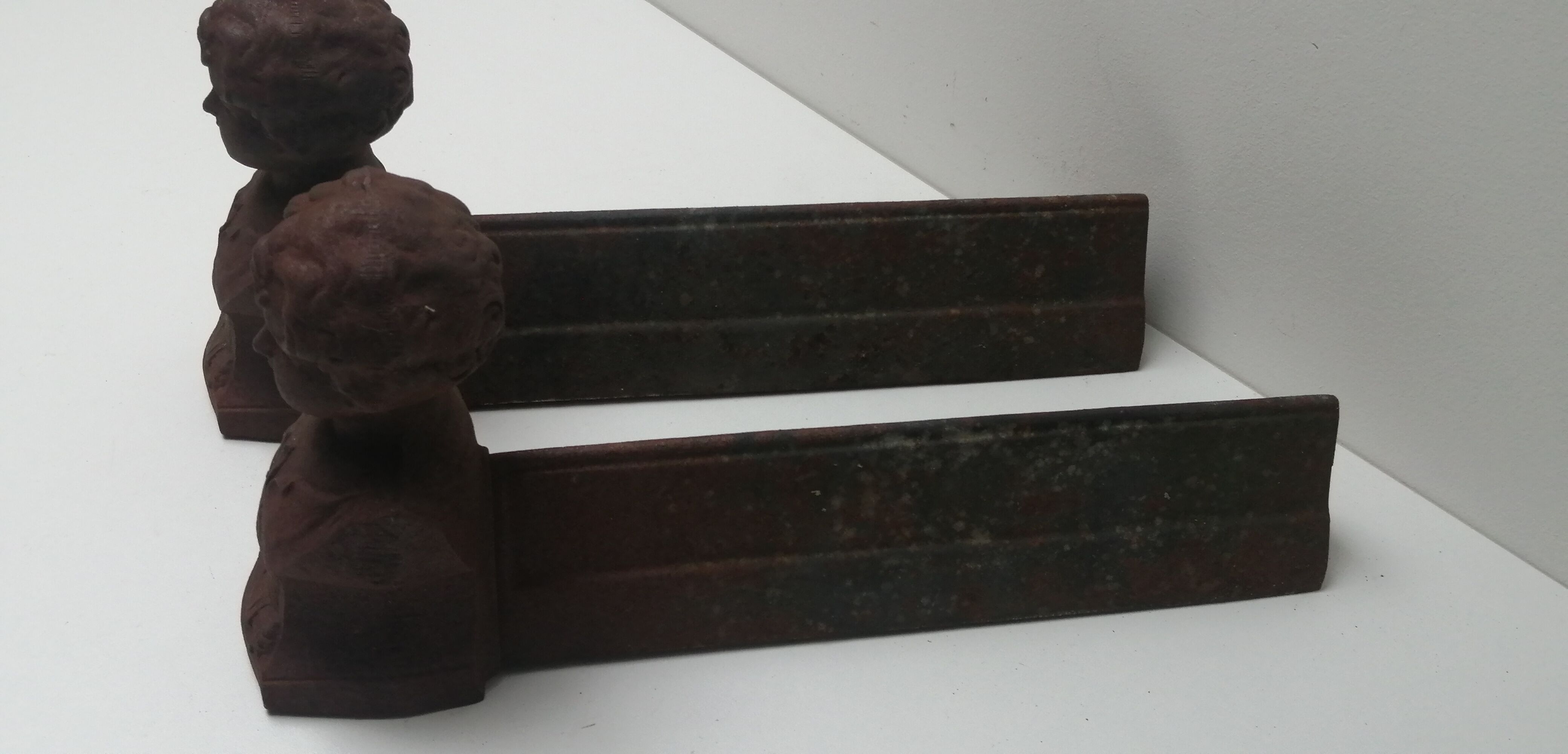 Pair of cast iron fireplace chenets "children"