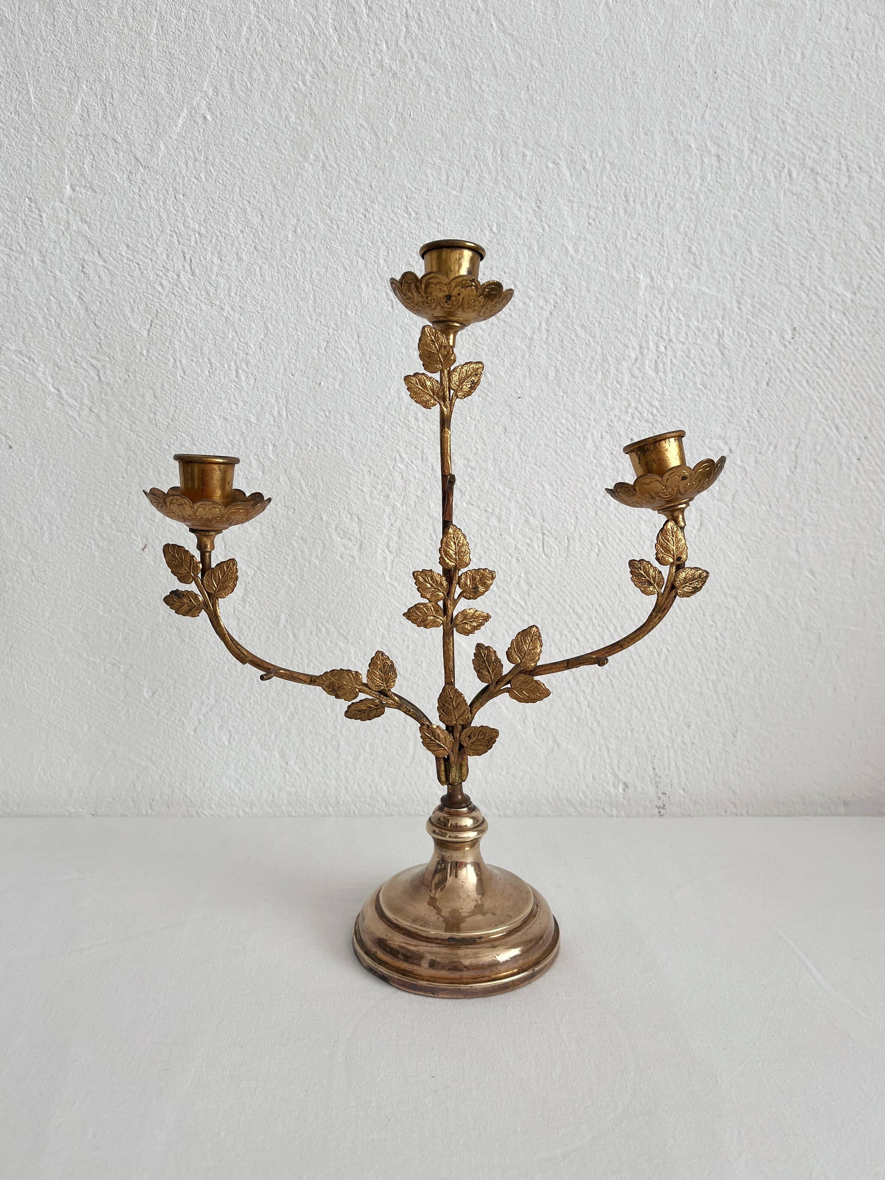 Antique bronze and brass candlestick with golden leaves