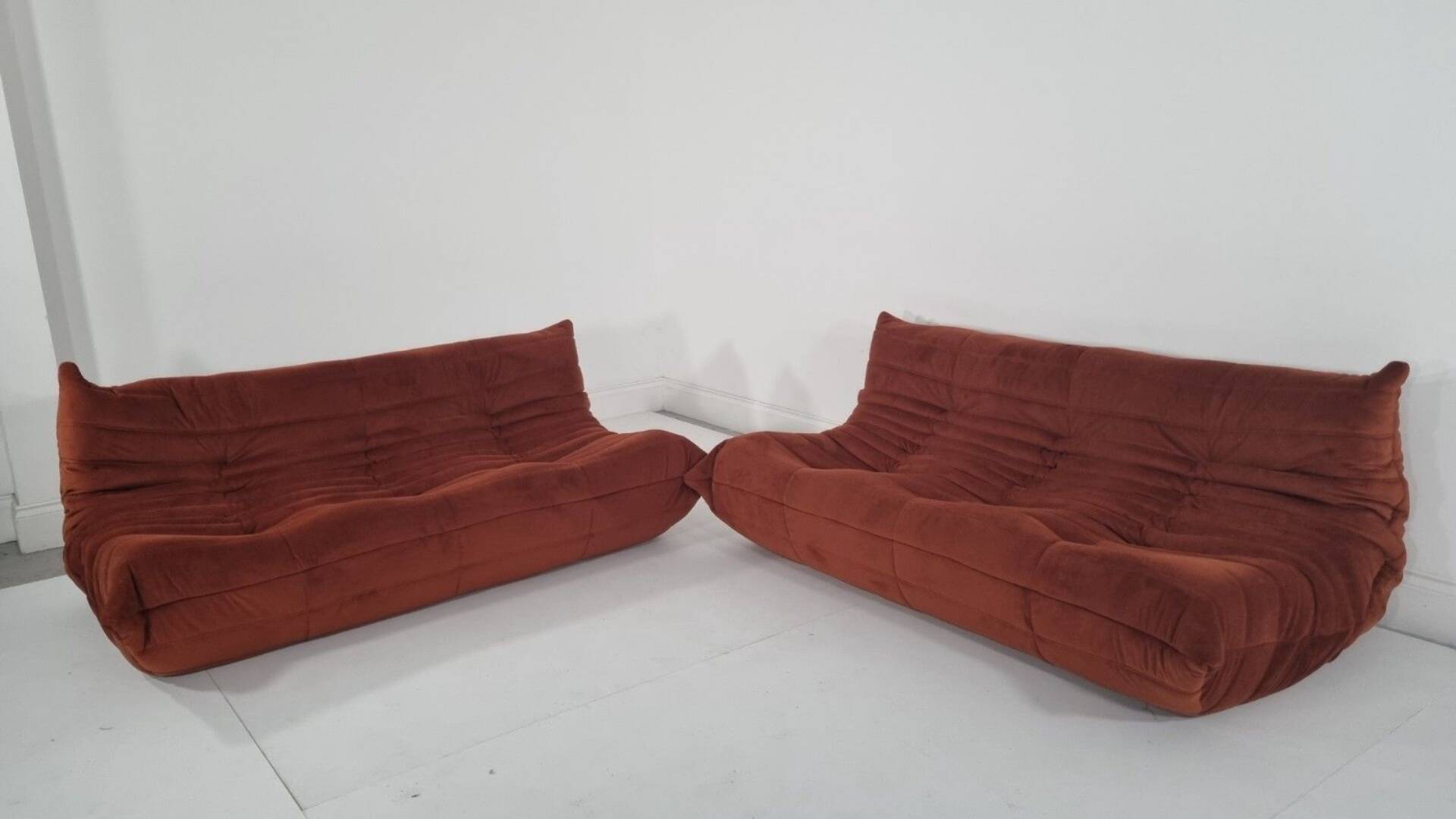 Ligne Roset Pair of 3-seater Togo sofas in rust velvet