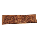 Bas-relief plaster scene of horses and a cart.