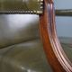 Elegant armchair and footrest in English green leather