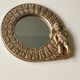 Miroir rond à décor de putti et floral