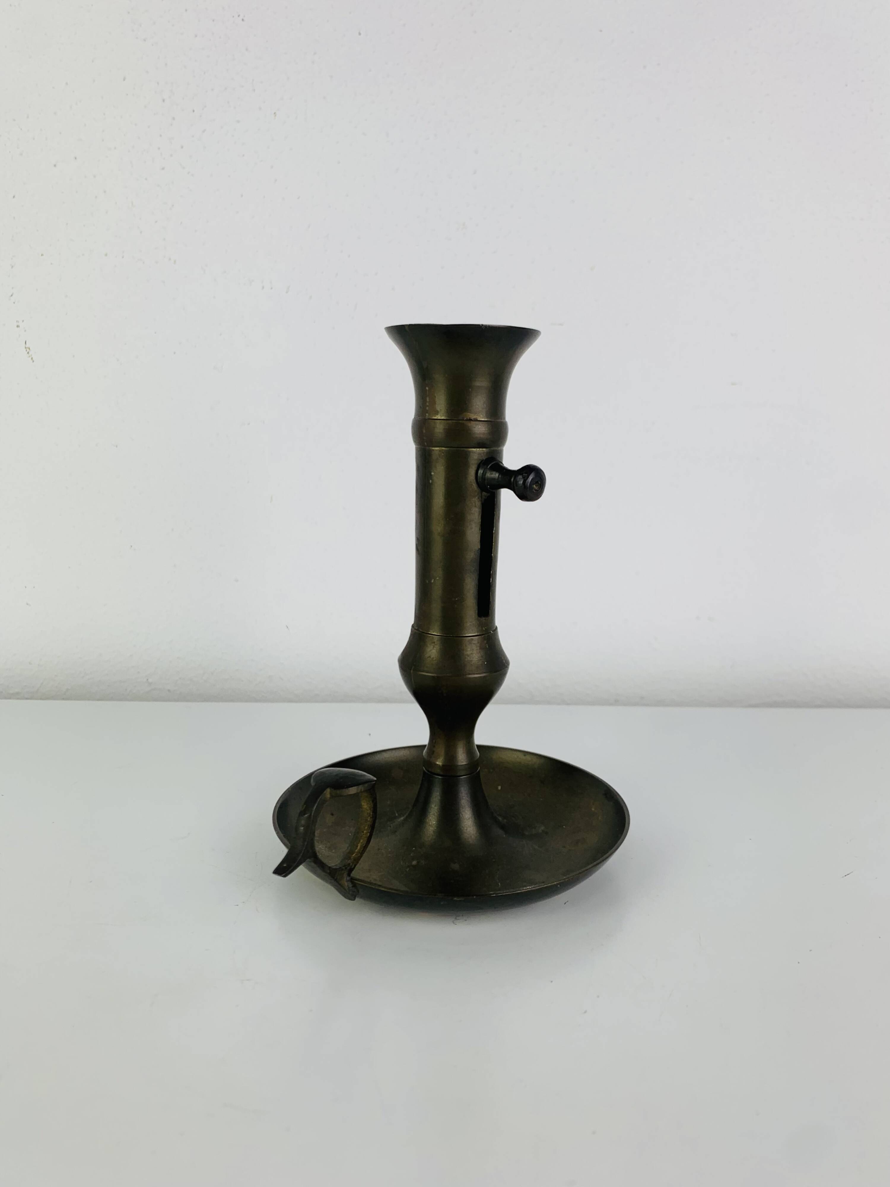 Vintage brass candlestick that raises and lowers.