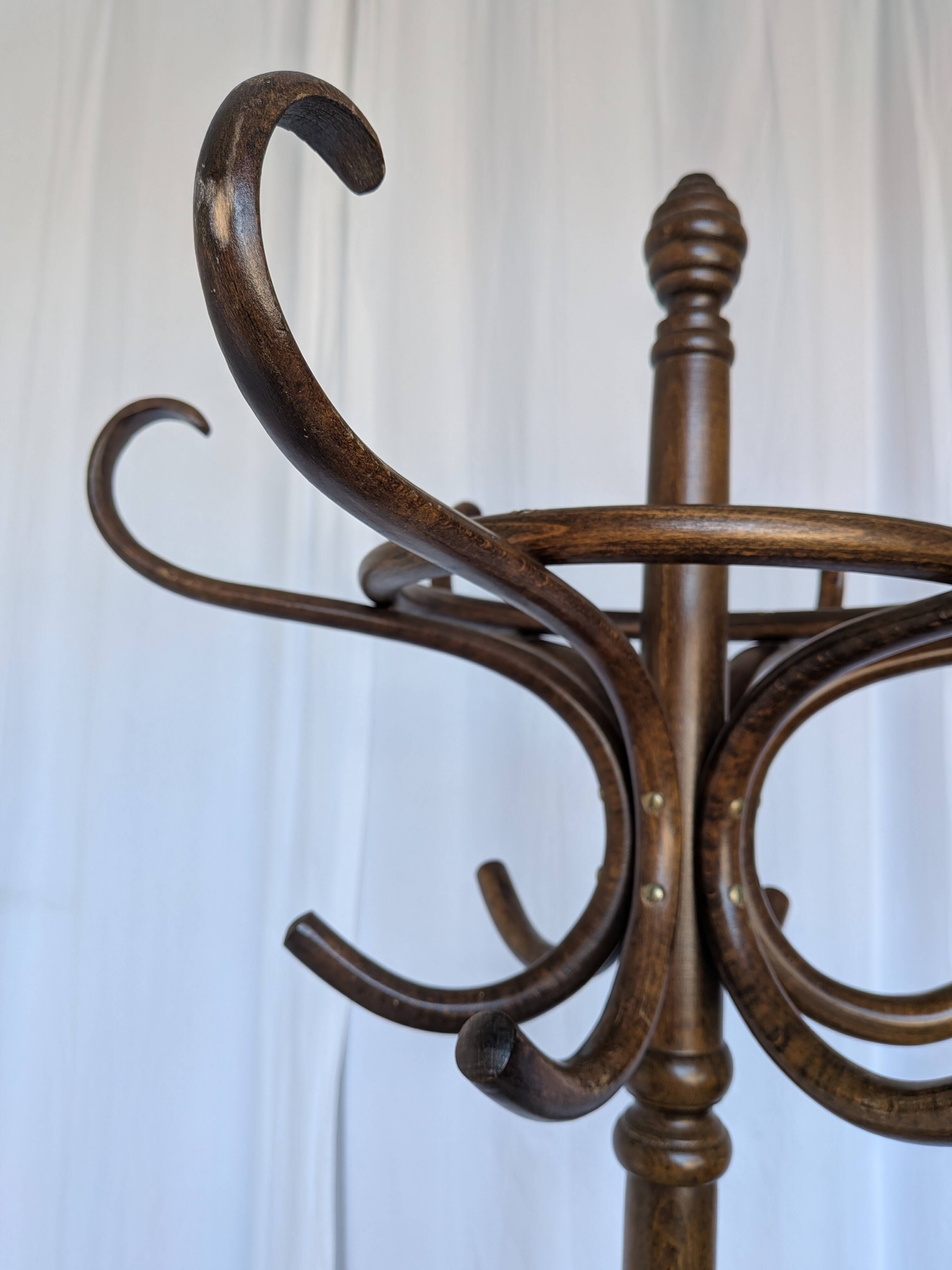 Vintage bentwood coat rack in Thonet style / Dark wood coat rack with shadow.