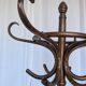 Vintage bentwood coat rack in Thonet style / Dark wood coat rack with shadow.