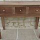 Console in solid walnut with a natural finish, featuring three drawers with a belt.