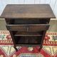 Oak accent furniture bookshelf with a drawer, early 20th century work.