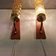 A set of Danish wall lights in champagne coloured glass with brass and teak.