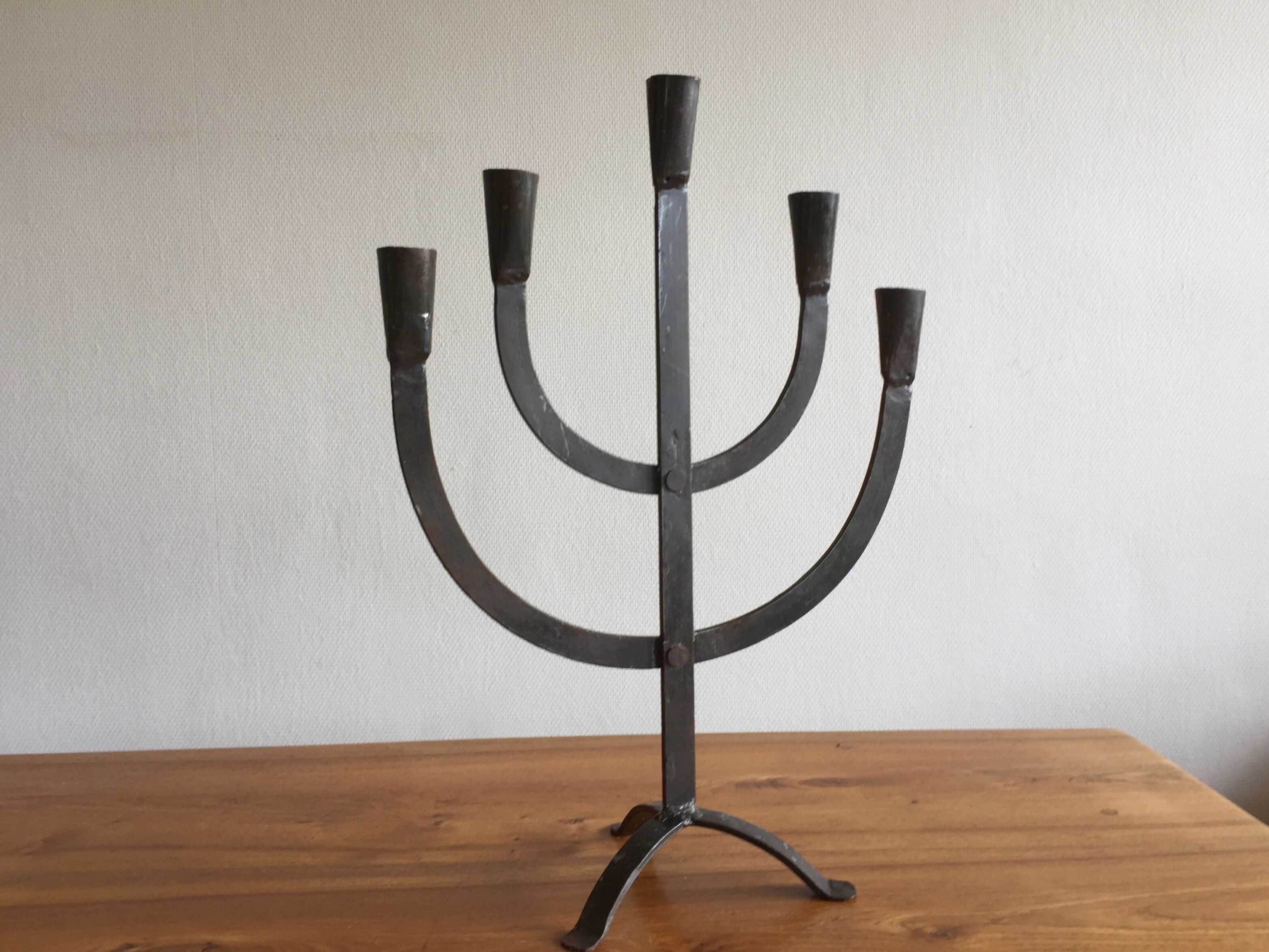 Old iron candelabra shaped high time