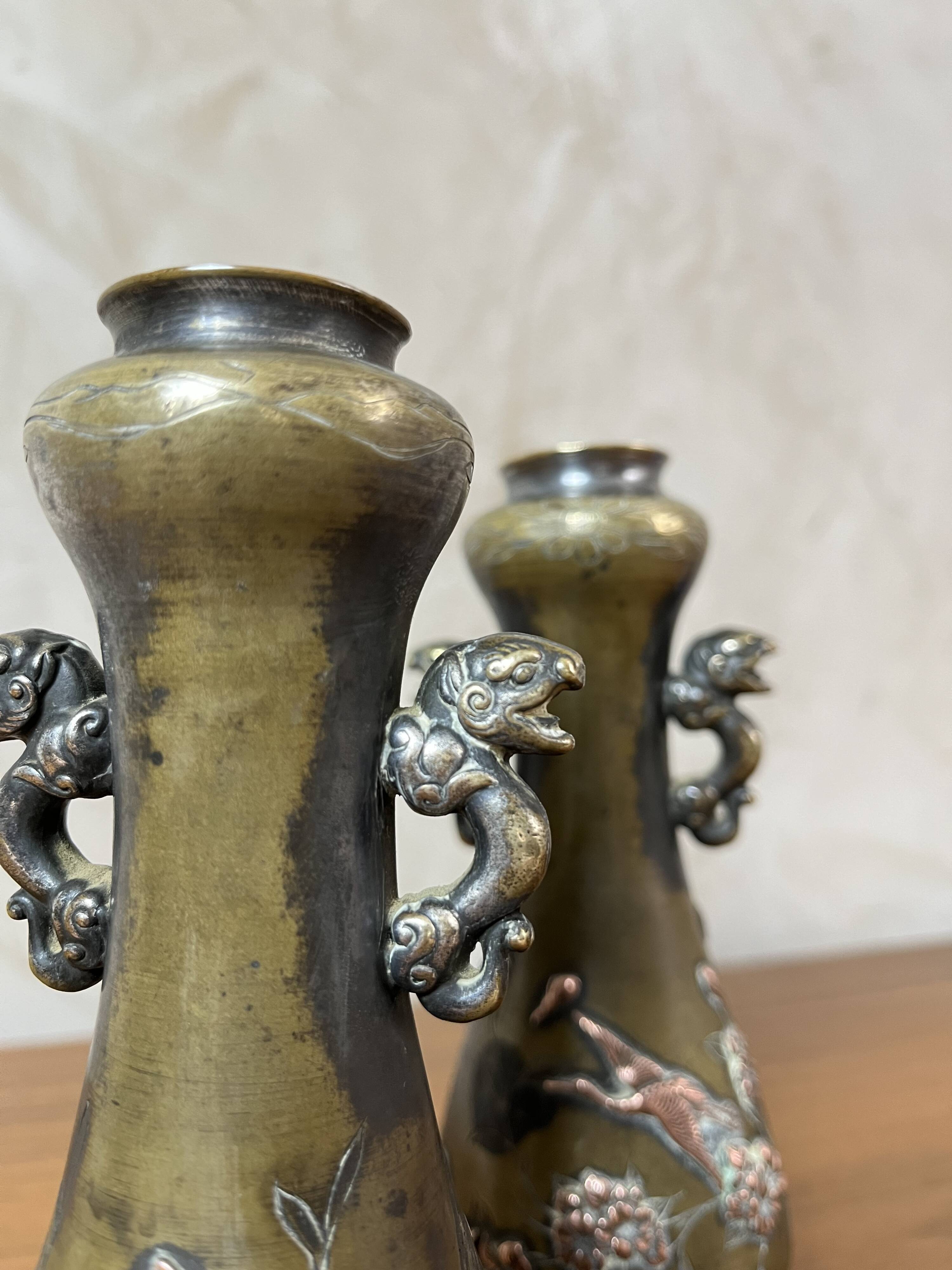 Pair of bronze vases - Asian motifs in relief in copper