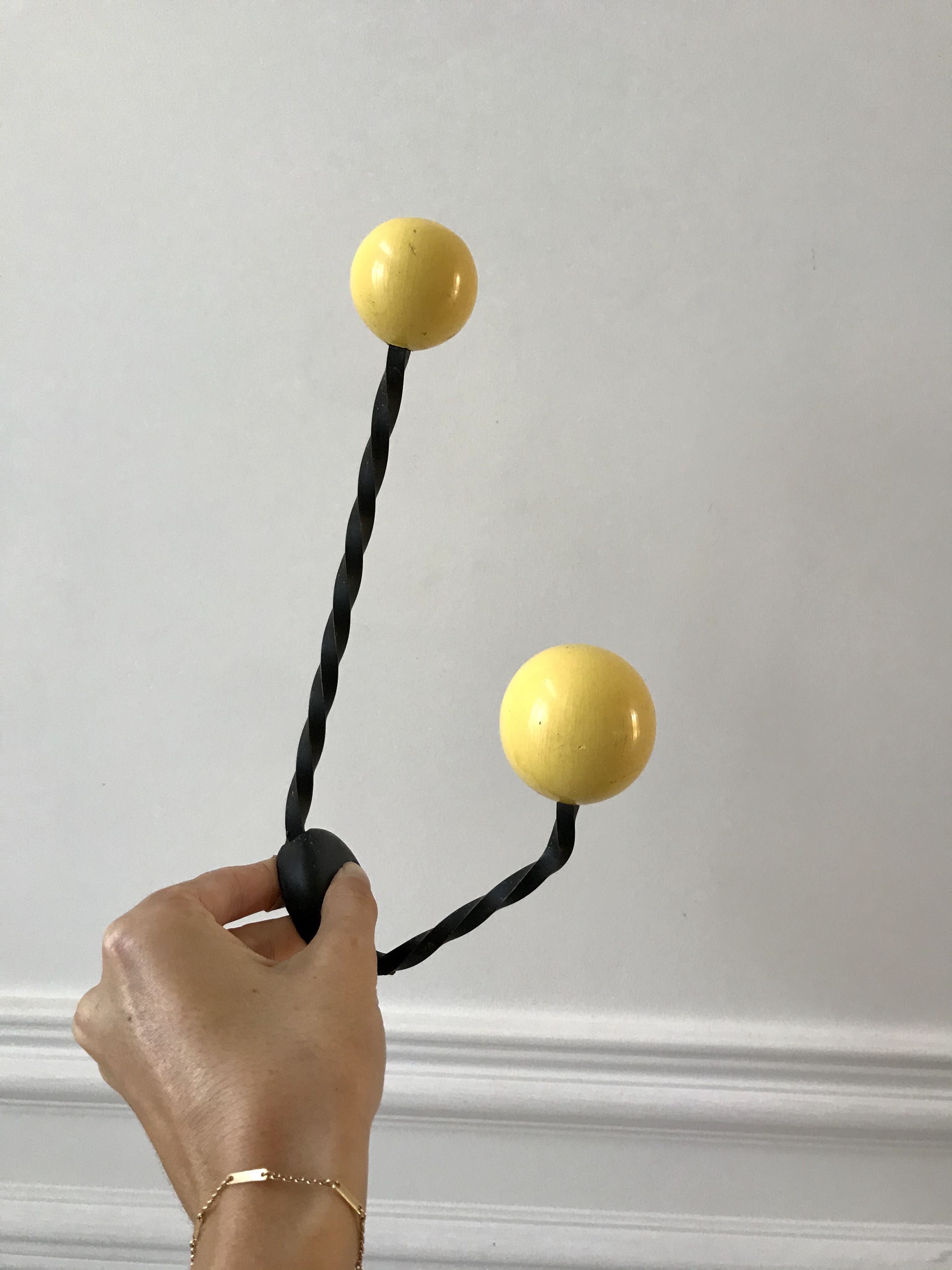 Duo of hooks balls in yellow wood and black iron 60s