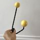 Duo of hooks balls in yellow wood and black iron 60s