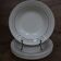 6 old cream-coloured deep plates with blue/orange trim.