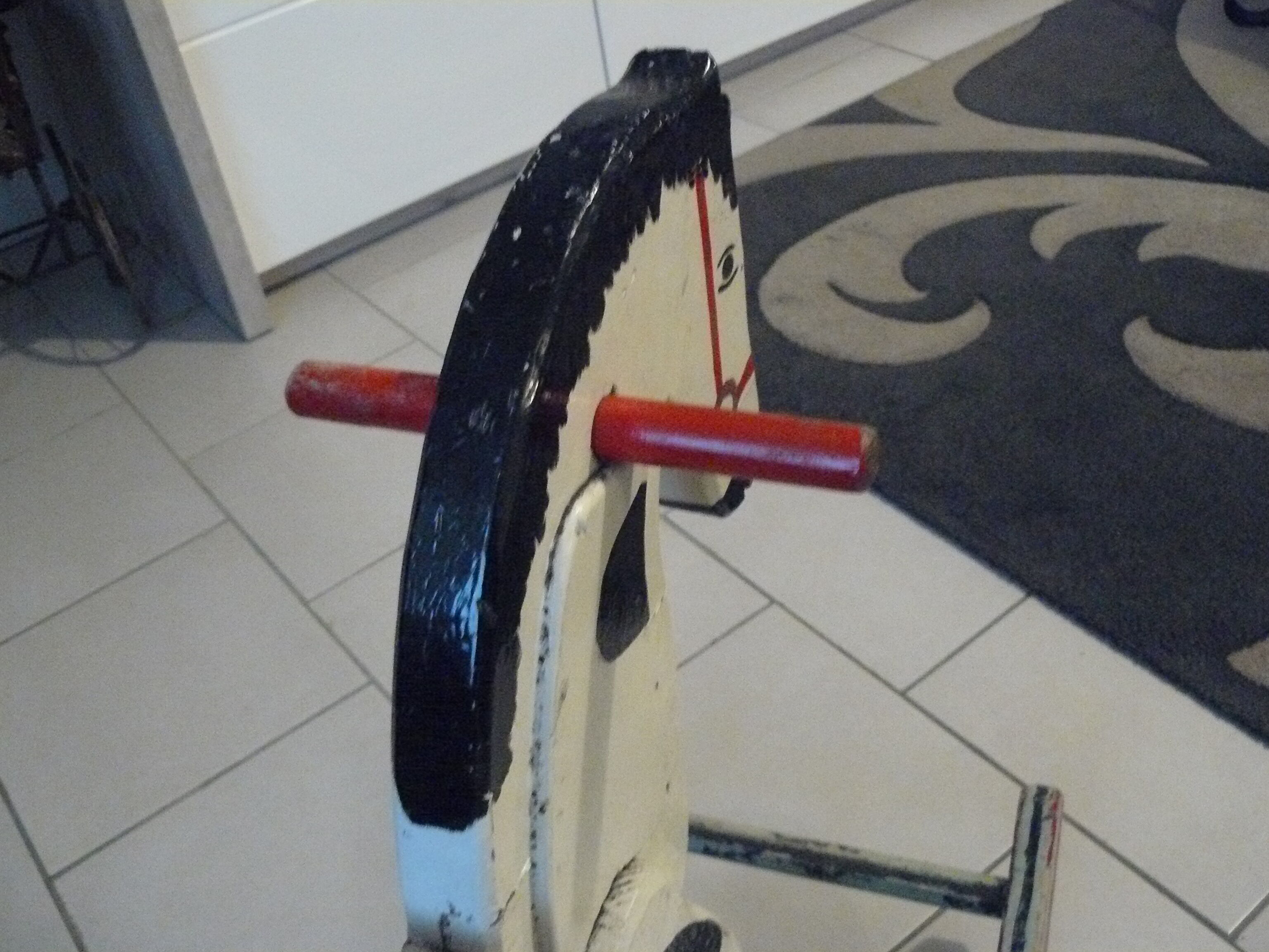 Old rocking horse in painted wood