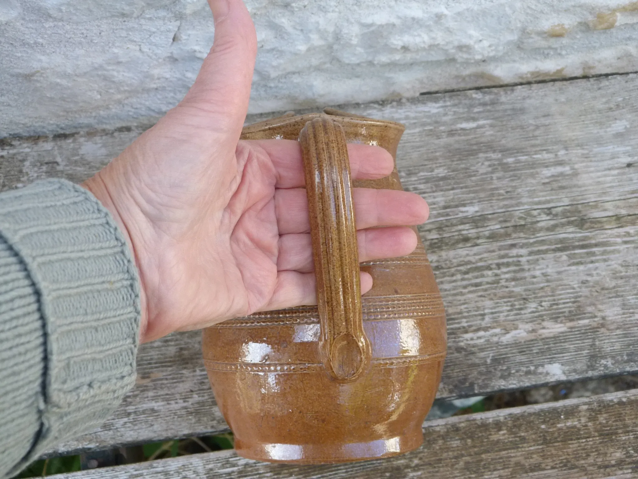 Old stoneware wine jug with patterns