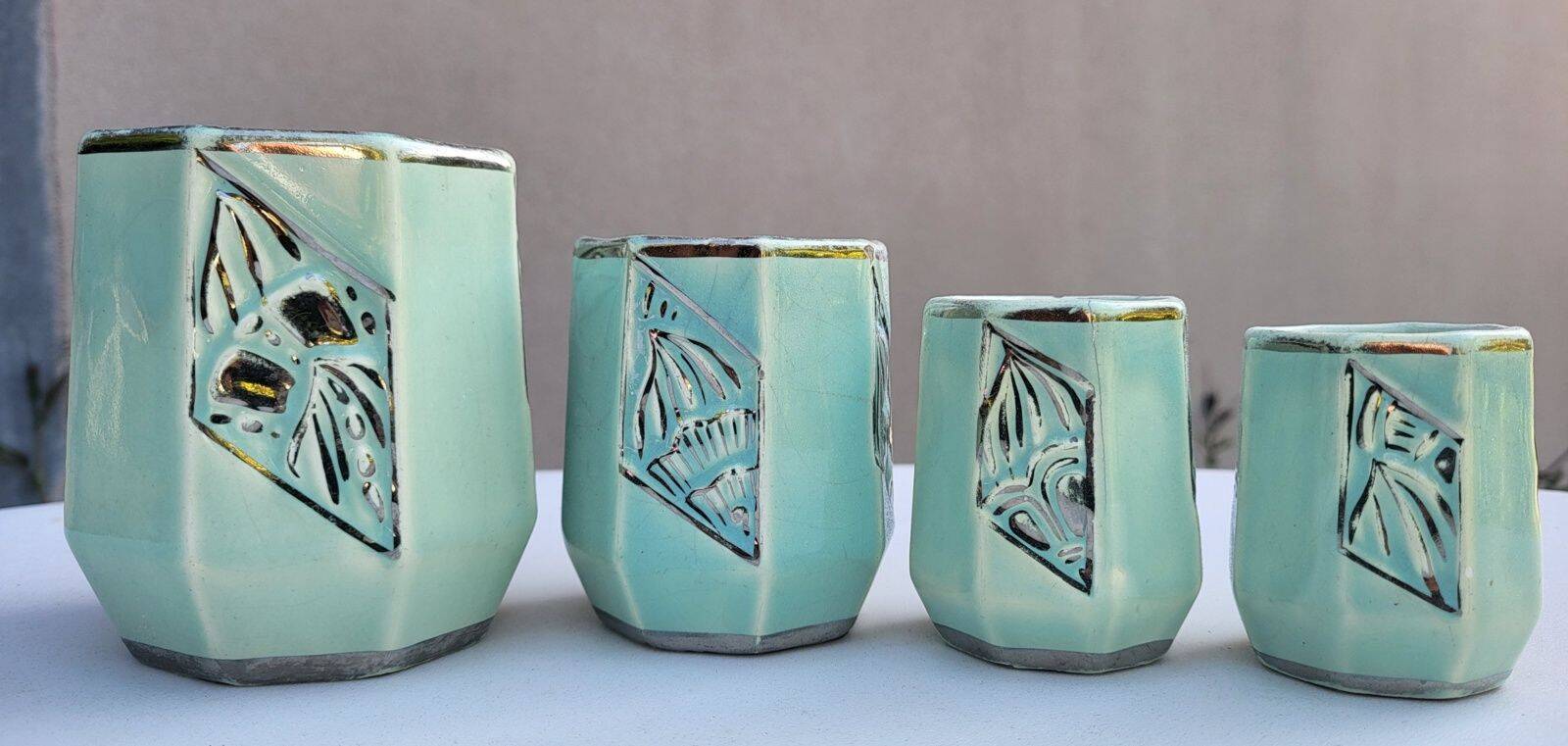 Set of 4 Art Deco celadon green and silver barbotine pots.