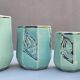Set of 4 Art Deco celadon green and silver barbotine pots.