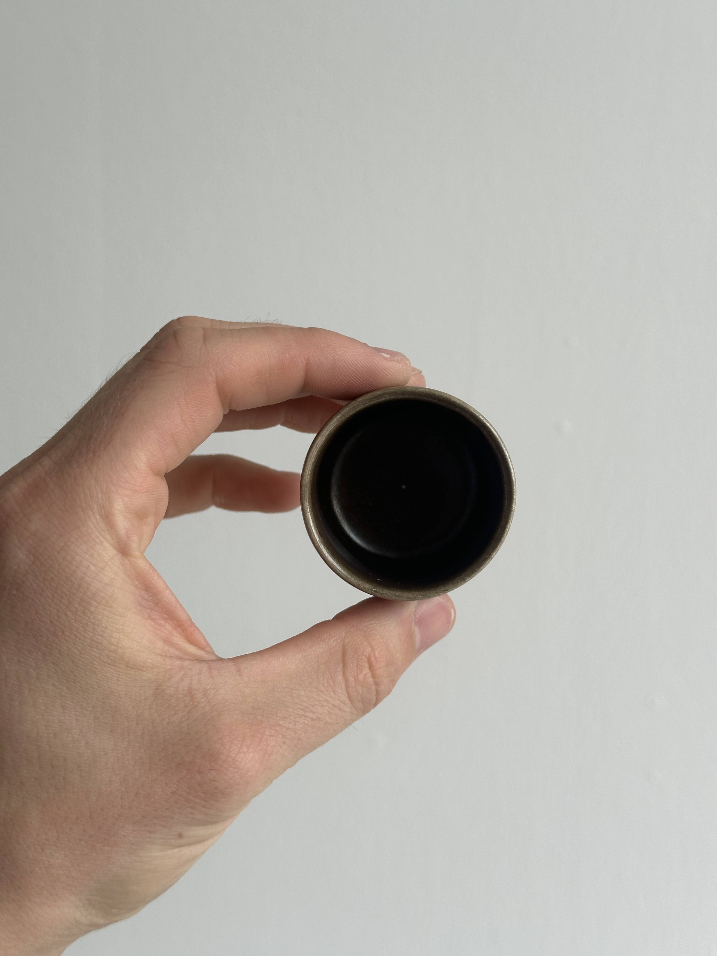 Set of 5 dark brown glazed ceramic egg cups.