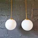 Pair of Art Deco pendant lights in brass and white opaline, 1920-30