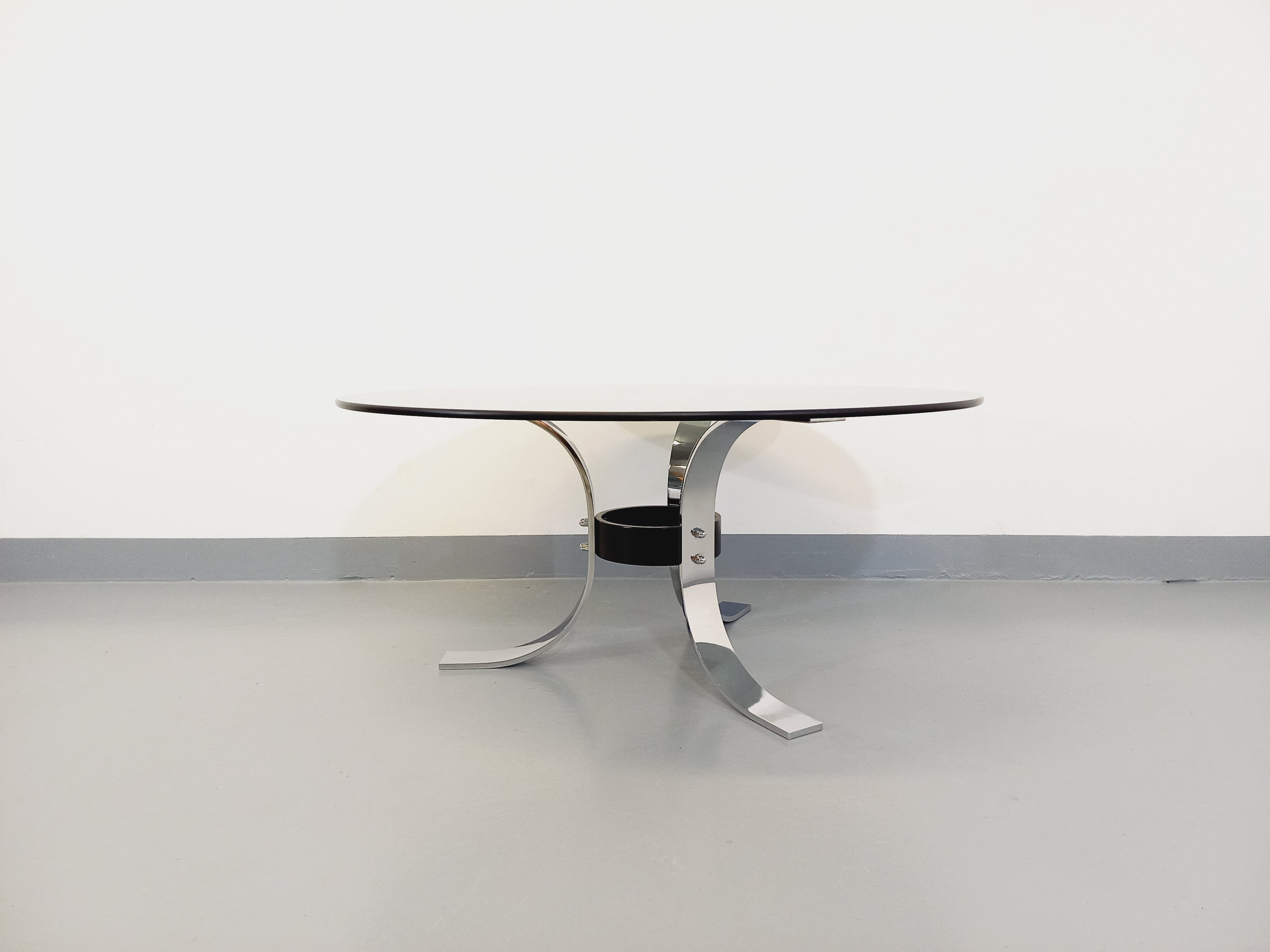Vintage round coffee table in glass, chromed metal and black metal Space Age style of the 70s