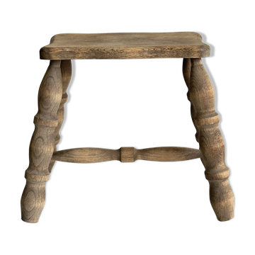 Antique wooden stool with four turned legs.