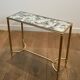 Pair of brass and antique mirror side tables from the Baguès house.