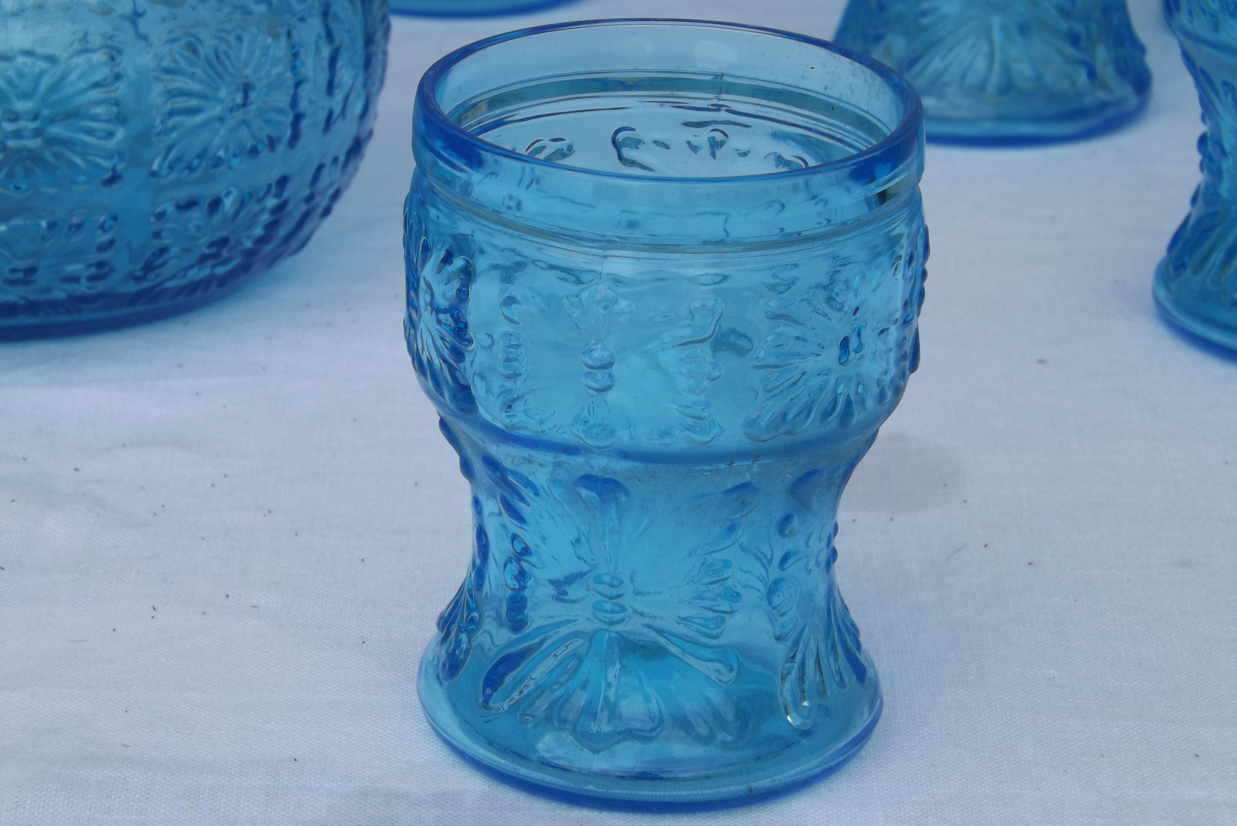Set of jug and 10 blue glass goblets with floral motifs
