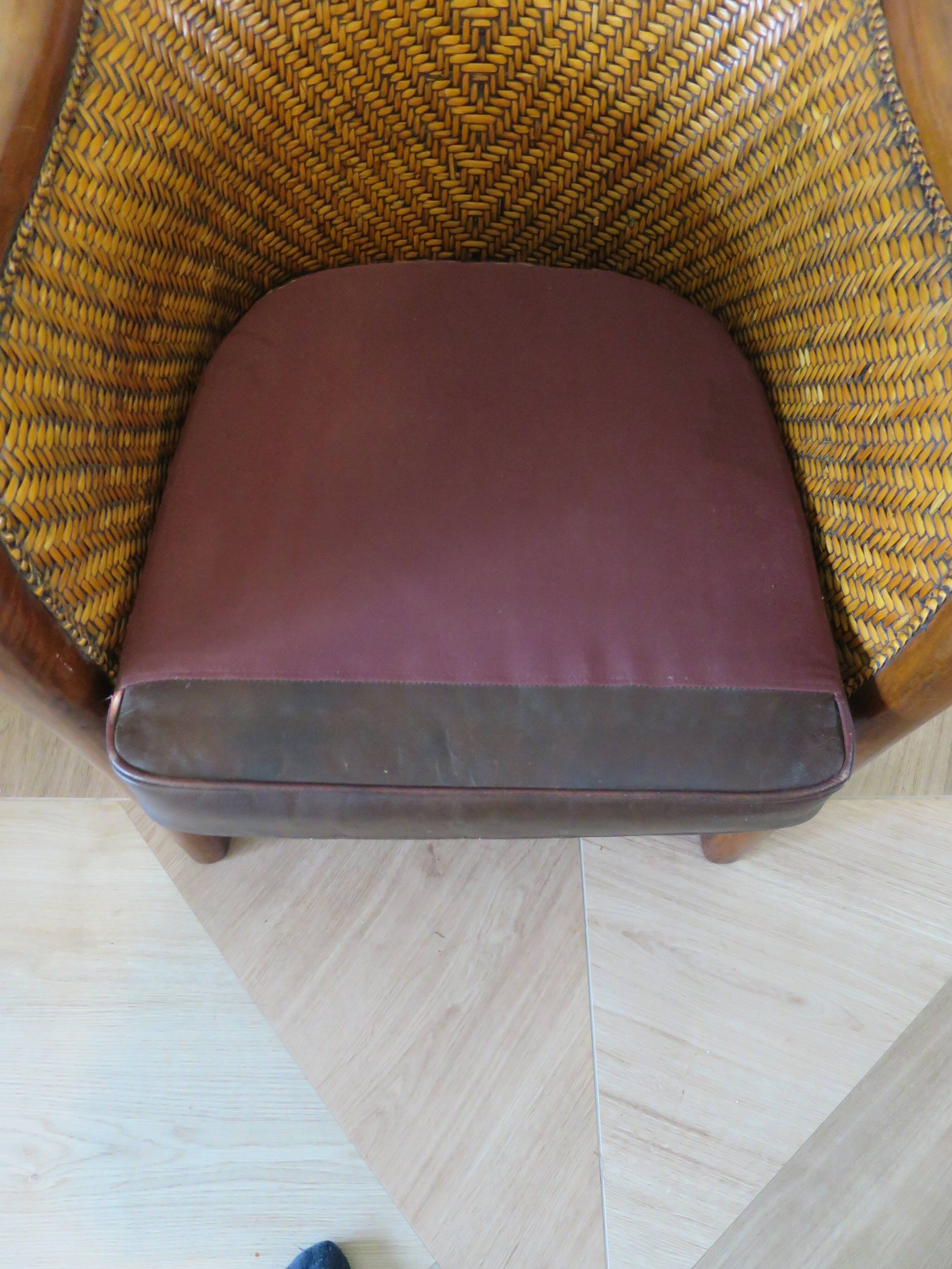 Colonial style armchair in woven rattan and exotic wood