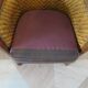 Colonial style armchair in woven rattan and exotic wood