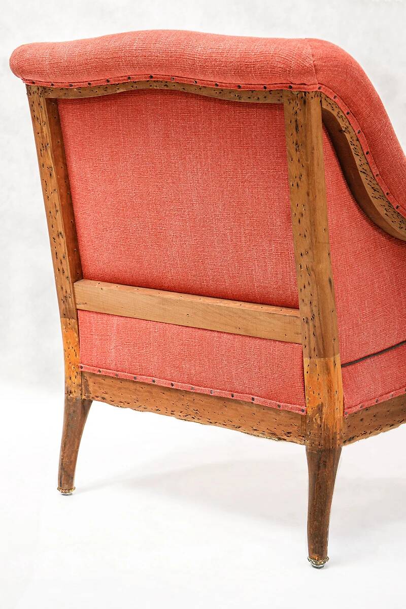Napoleon III salon armchair in brick red linen with a tufted footrest.