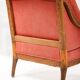 Napoleon III salon armchair in brick red linen with a tufted footrest.
