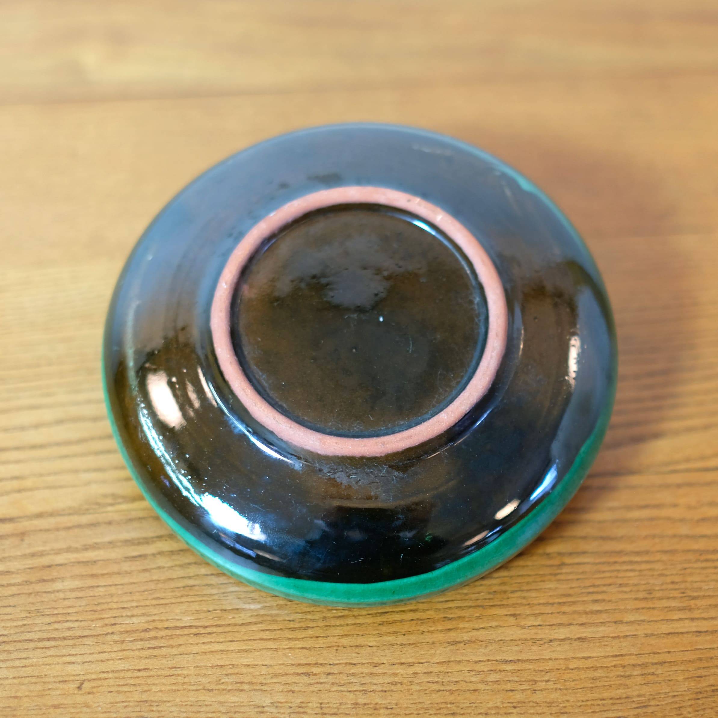 Glazed green earthenware candlestick