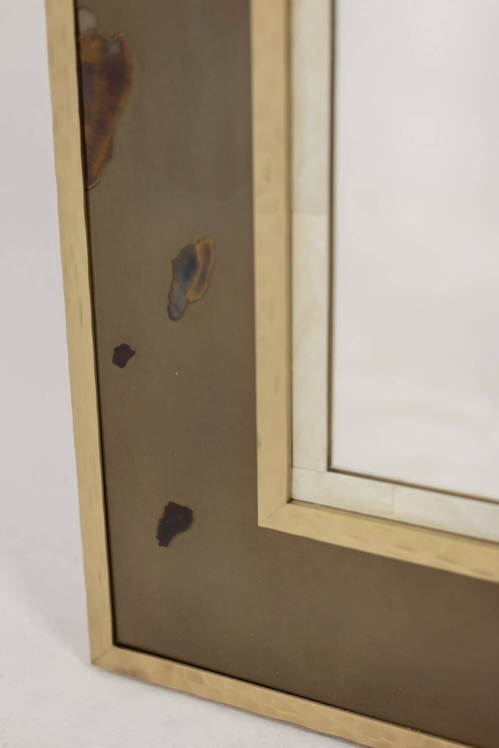 Mirror in marquetry of oxidised and patinated brass. Artist's work.