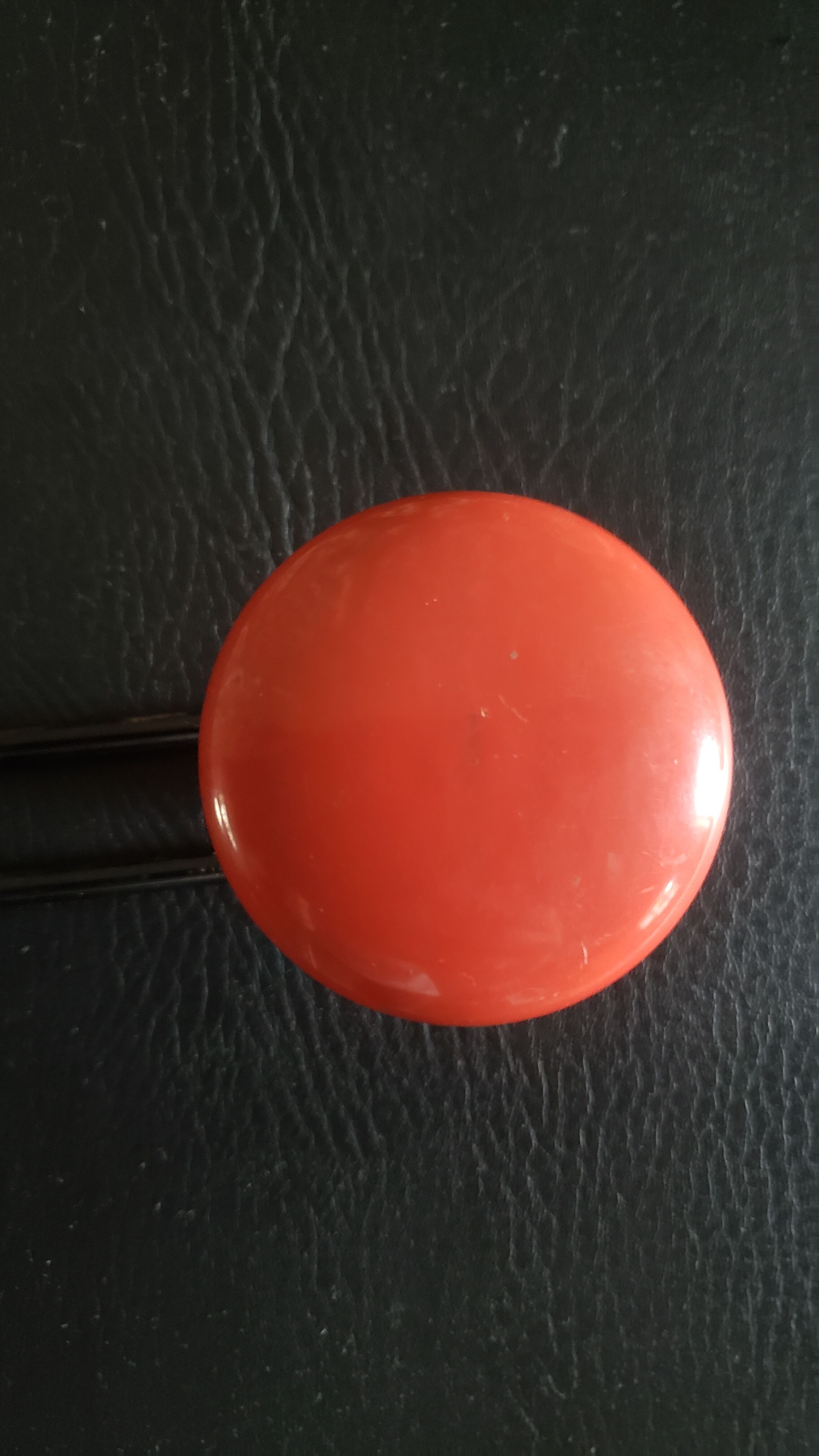 Metal coat rack with 2 red hooks