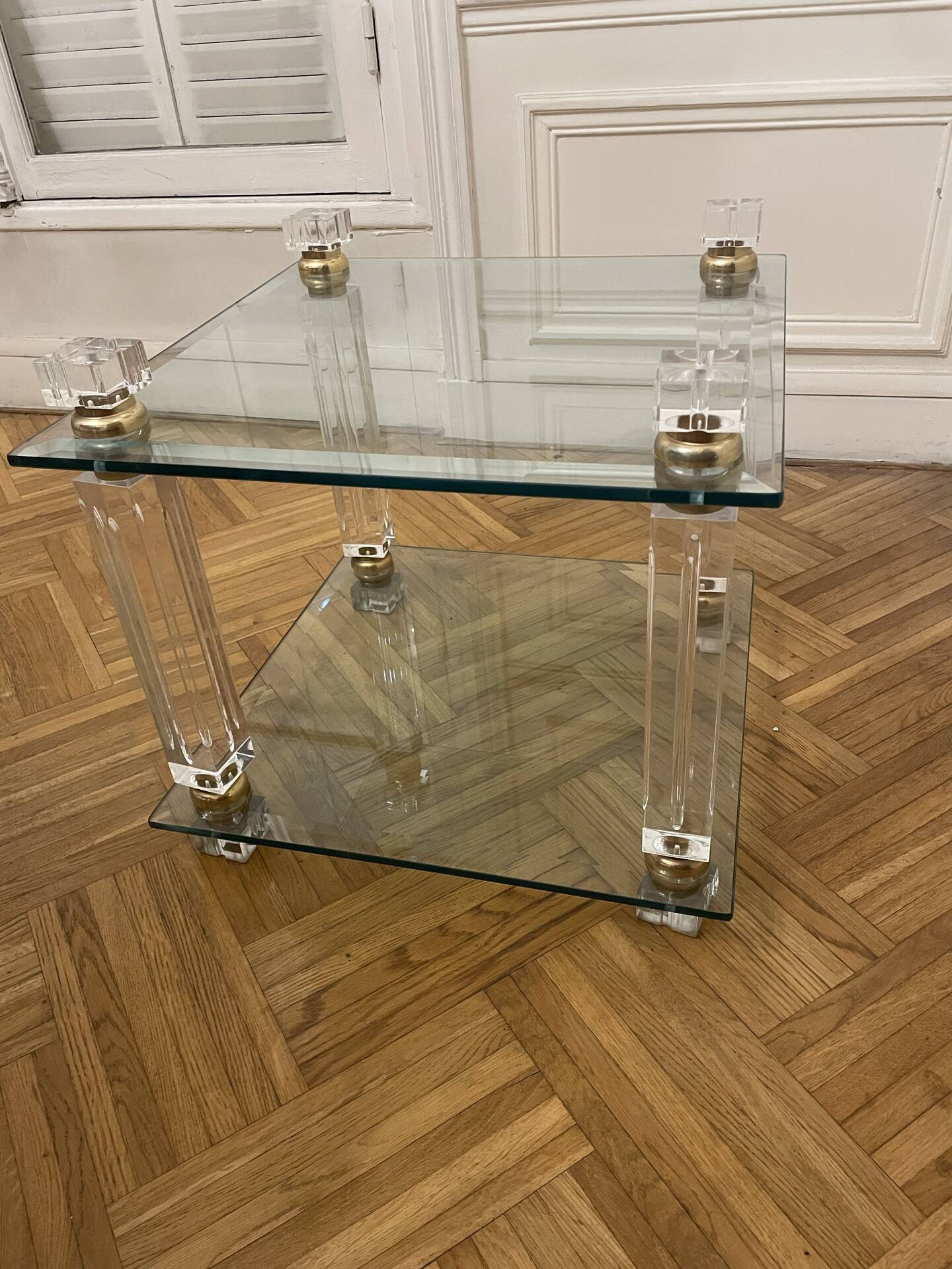 Glass side table with gold decorations.
