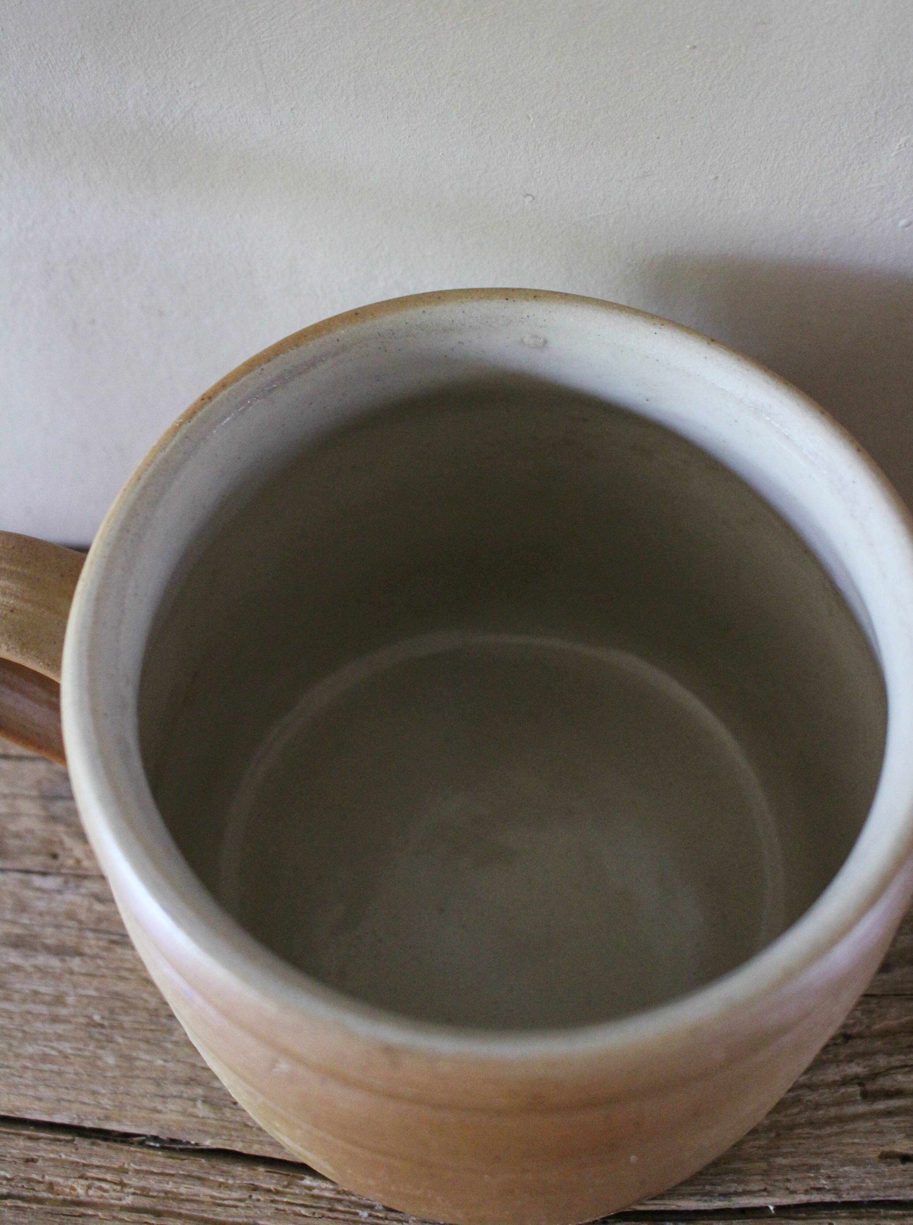 Vase terracotta milk jug with a glazed interior handle.