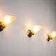 Set of three brass sconces with decorated yellow glass shades