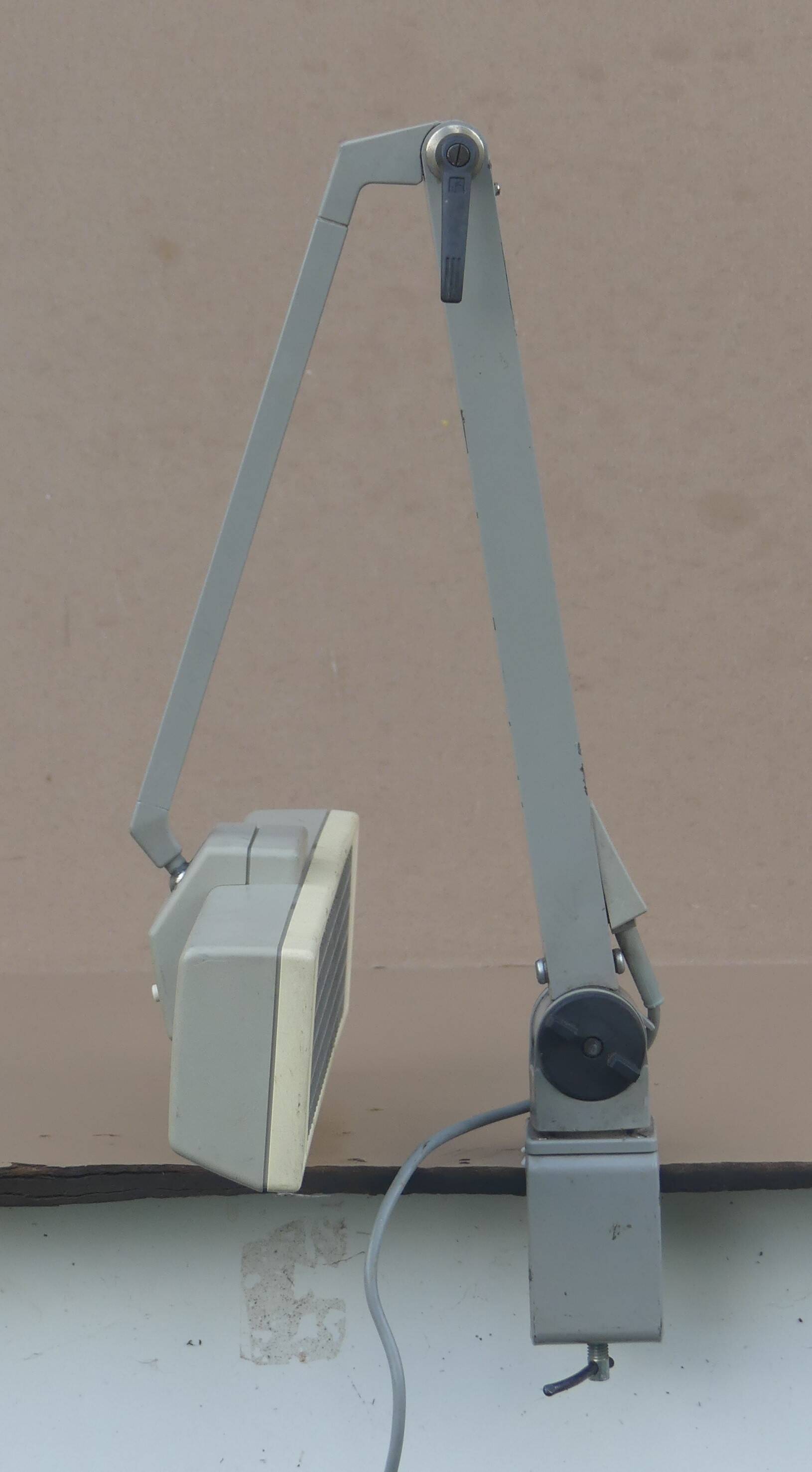 WALDMANN articulated workshop lamp with two industrial clamp arms for architects.